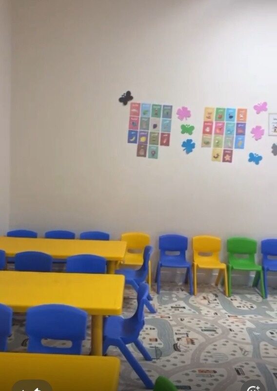 قاعة وحدة الطفولة بطاولات وكراسي ملوّنة